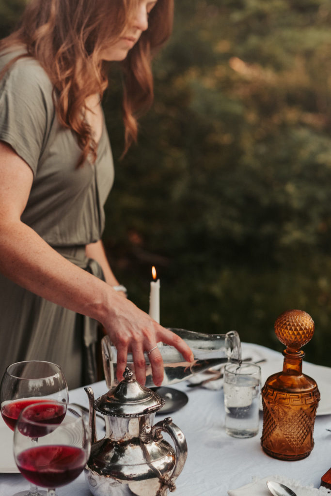 outdoor table scape with women filling up water glasses