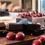 cherries and gummies on a wood board