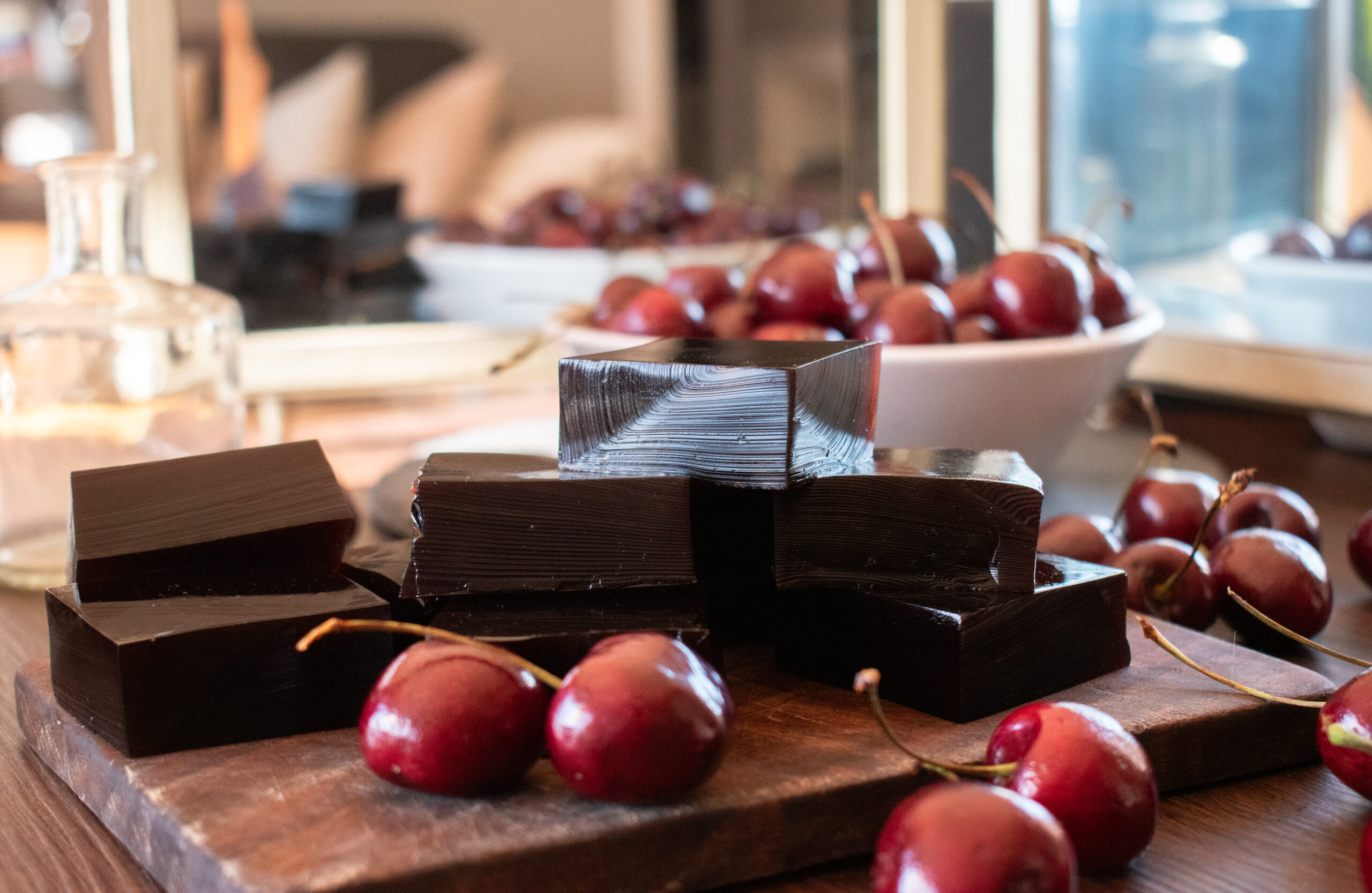 cherries and gummies on a wood board