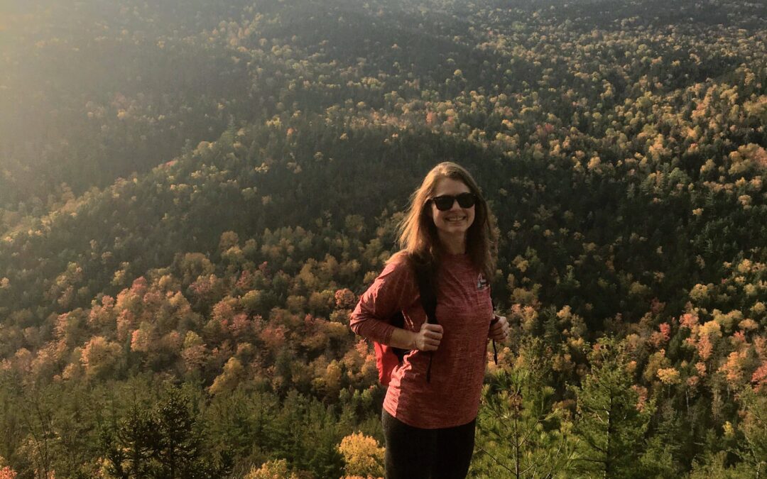 Girl with backpack on mountain hiking