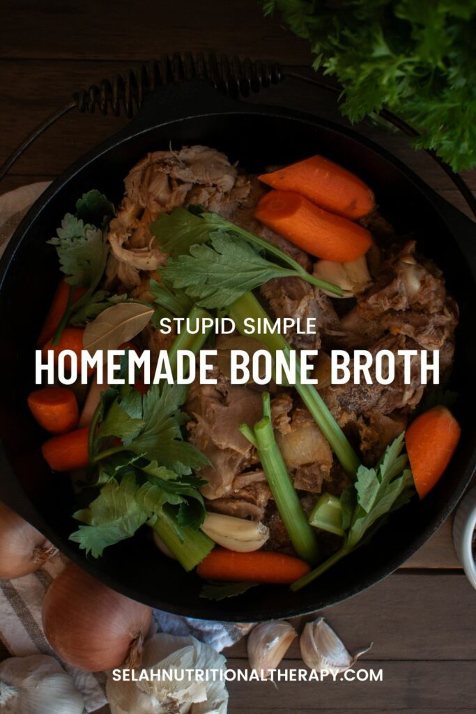 cast iron pot full of vegetables and bones overhead shot