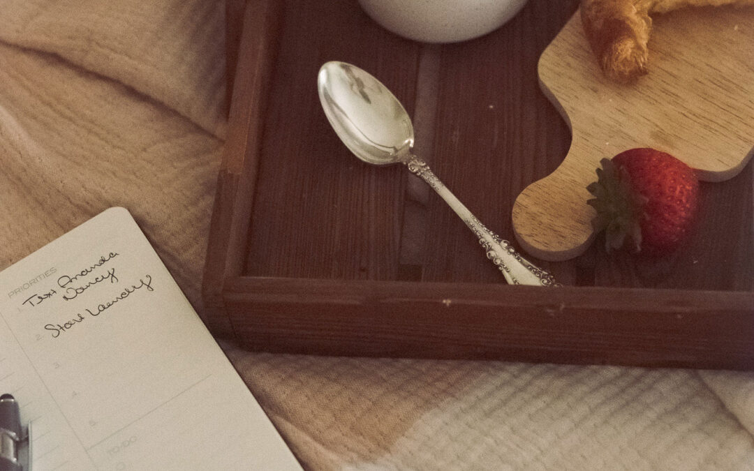 overhead shot of a planner with a croissant and berries and whipped cream on a tray