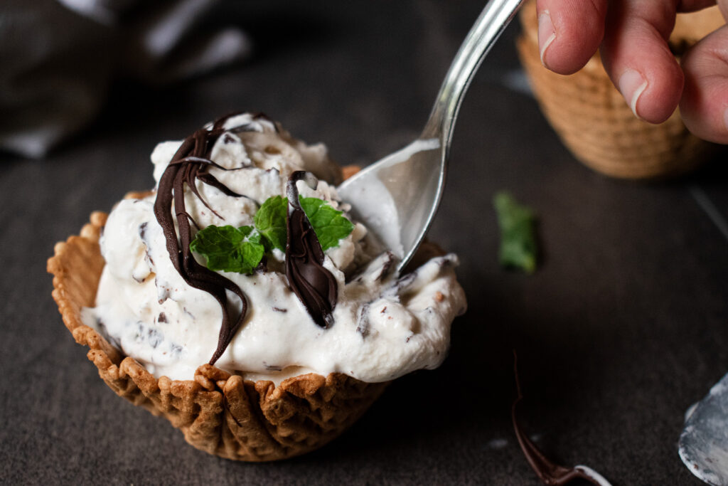 waffle bowl of ice cream with a spoon inserted