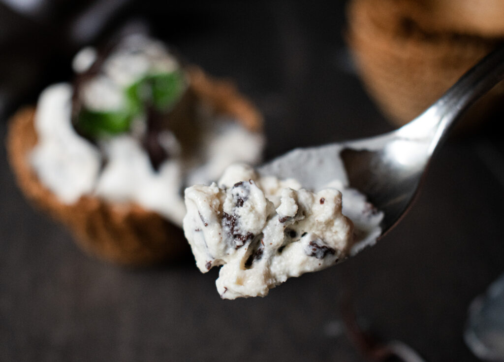 close up shot of bite of mint chocolate chip ice cream