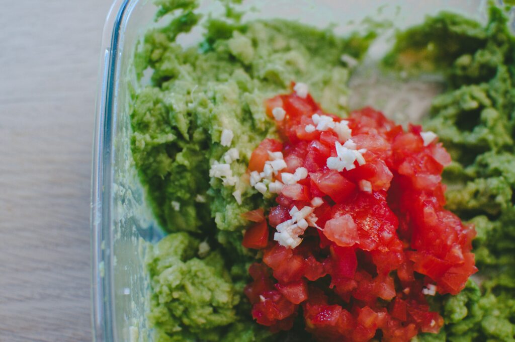 close up shot of some guacamole before it is mixed