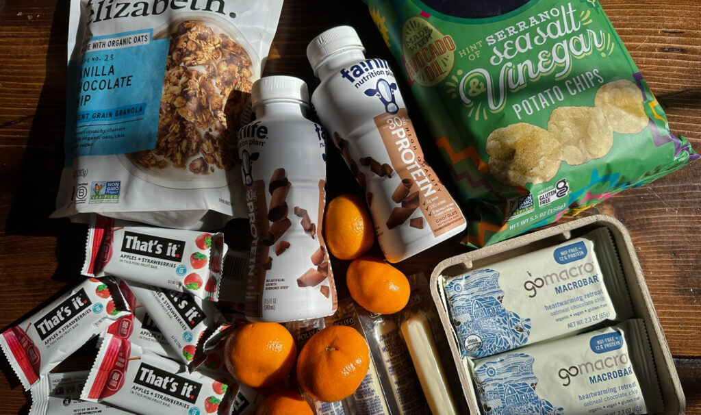 overhead shot of various snacks set for travel